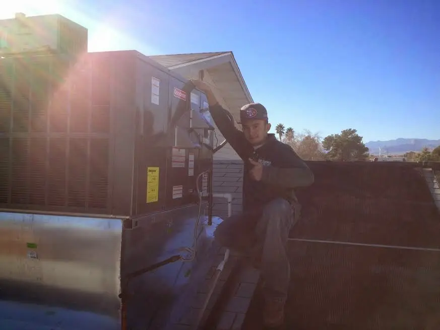 HVAC technician performing Air Duct Repair on a rooftop unit in Hamlin